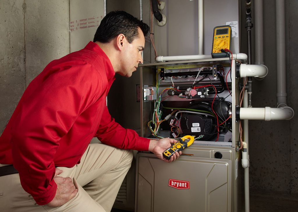 HVAC technician repairing an indoor furnace in Arvada