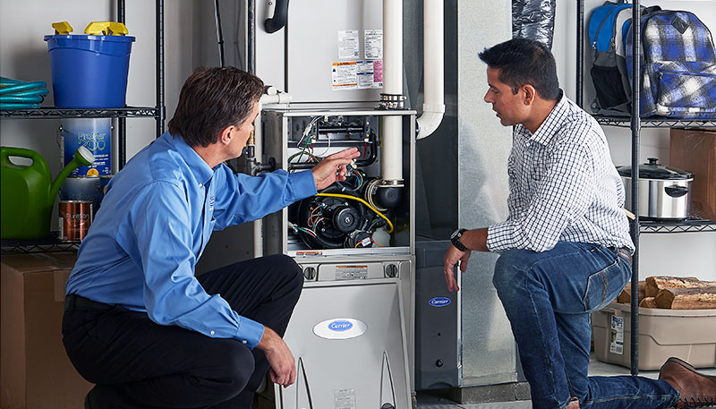 HVAC technician evaluating a furnace for repair or replacement in Arvada