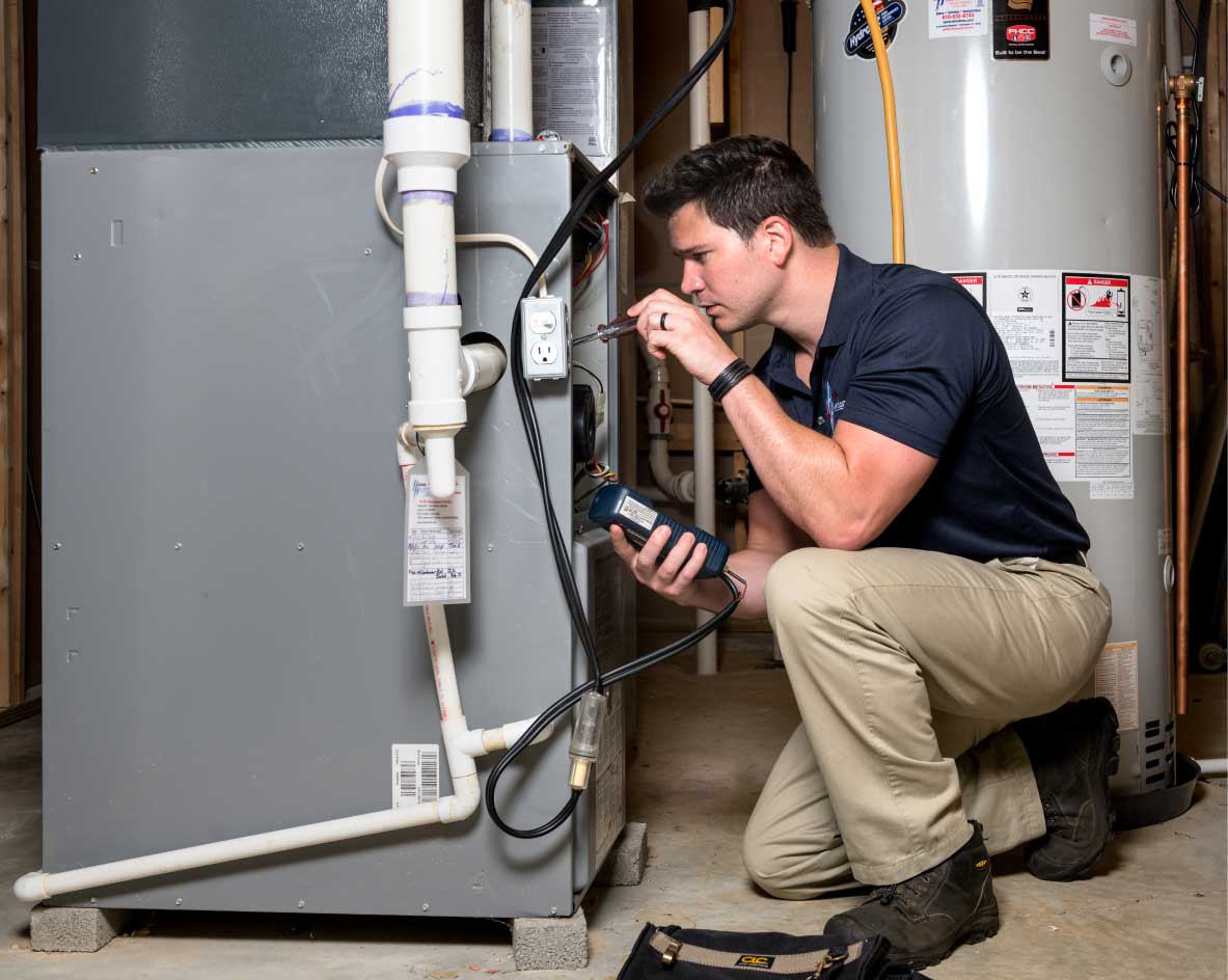 HVAC technician performing a furnace tune-up in Arvada