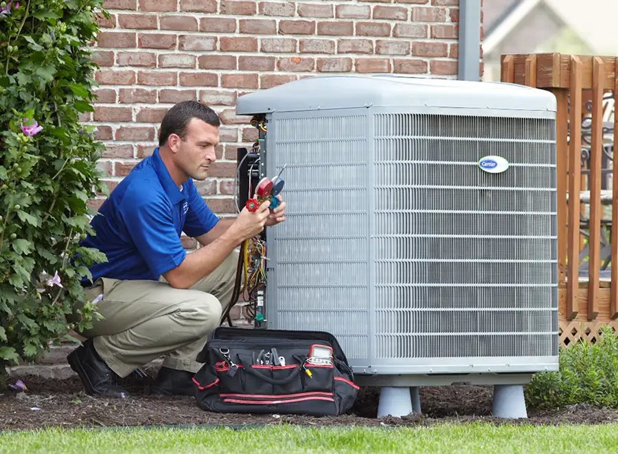 HVAC technician inspecting an outdoor air conditioning unit in Arvada