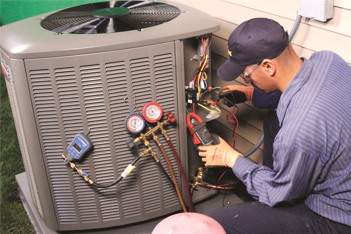 HVAC technician testing an outdoor air conditioning unit in Arvada